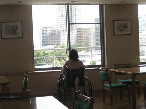 Sumiye looking outside on wheelchair